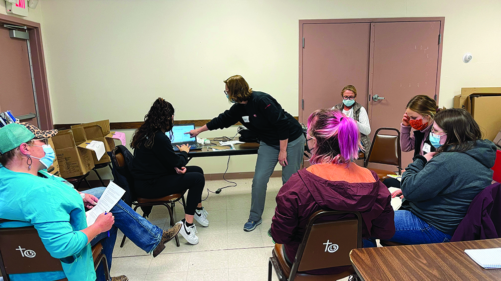 Nursing students talk with clients in Pine Ridge